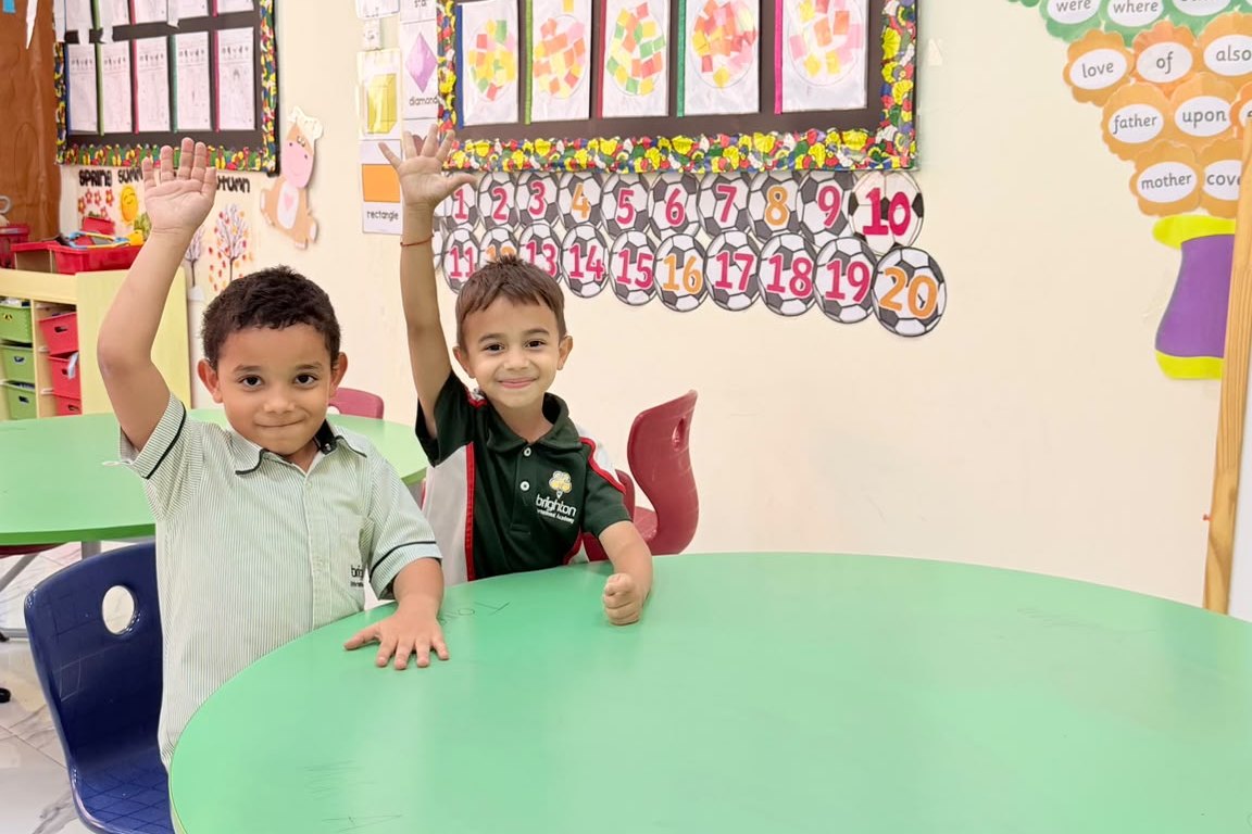 Smiling Early Years students in their classroom